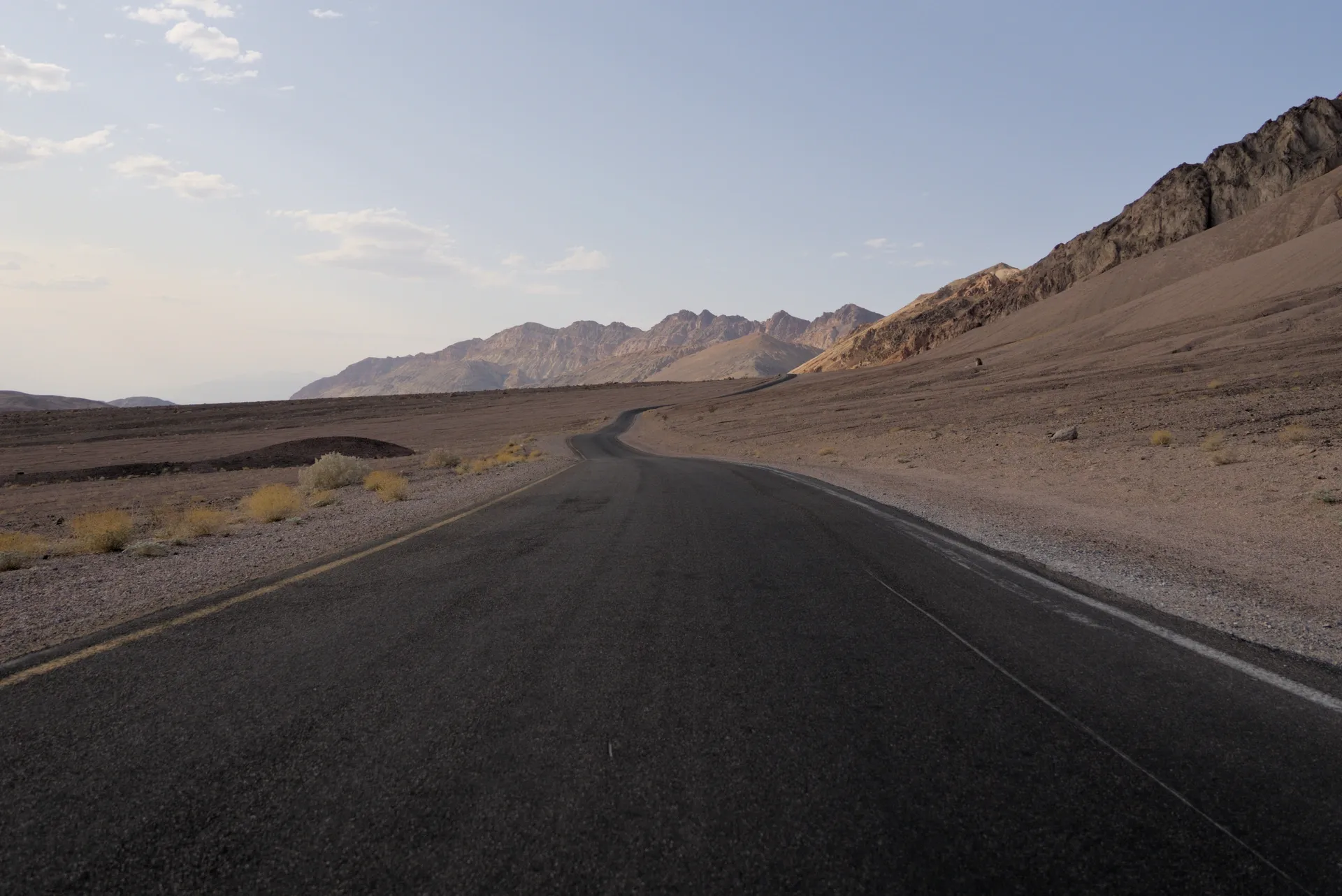 Empty desert road at the mountains.