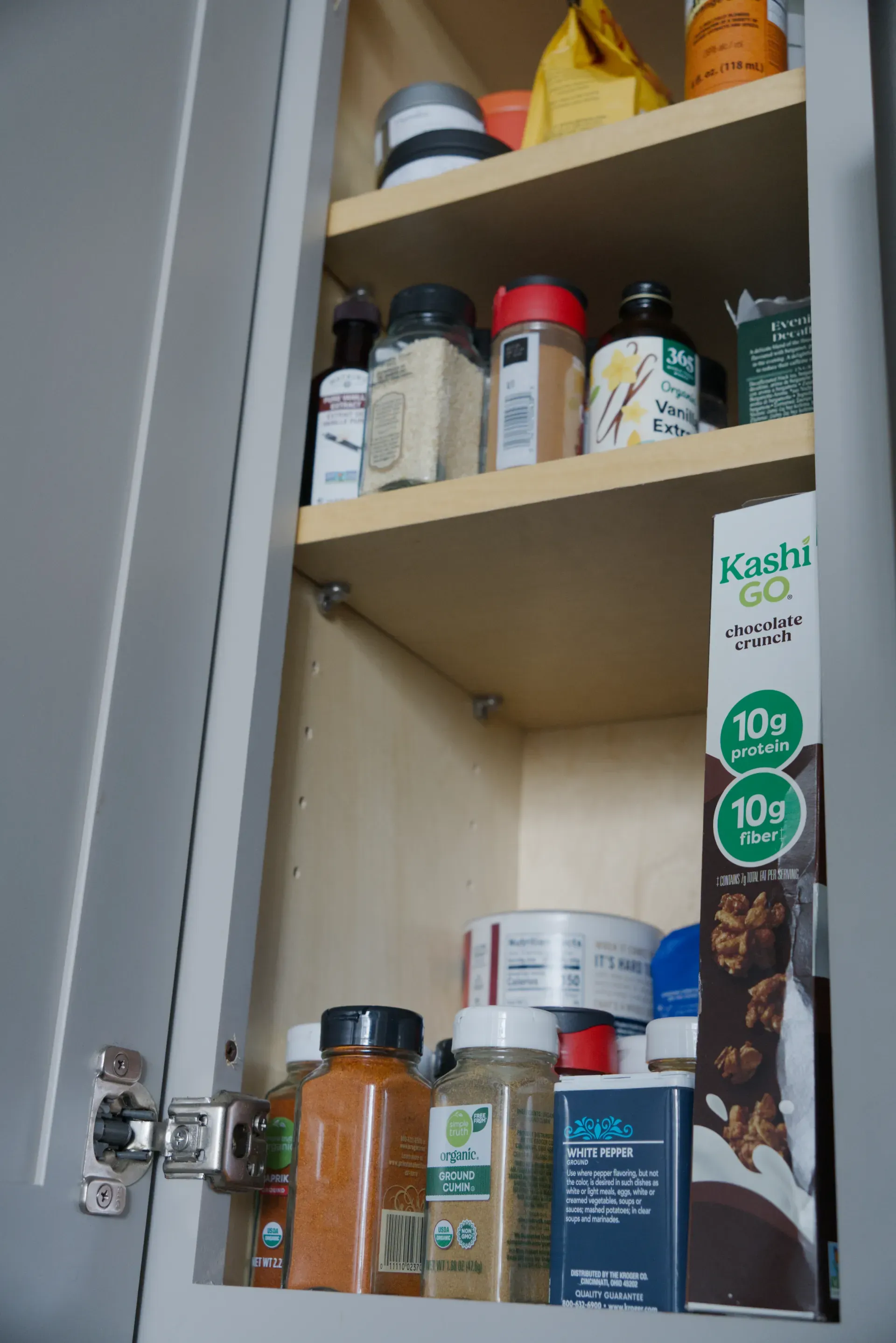 a cabinet with spices and other things