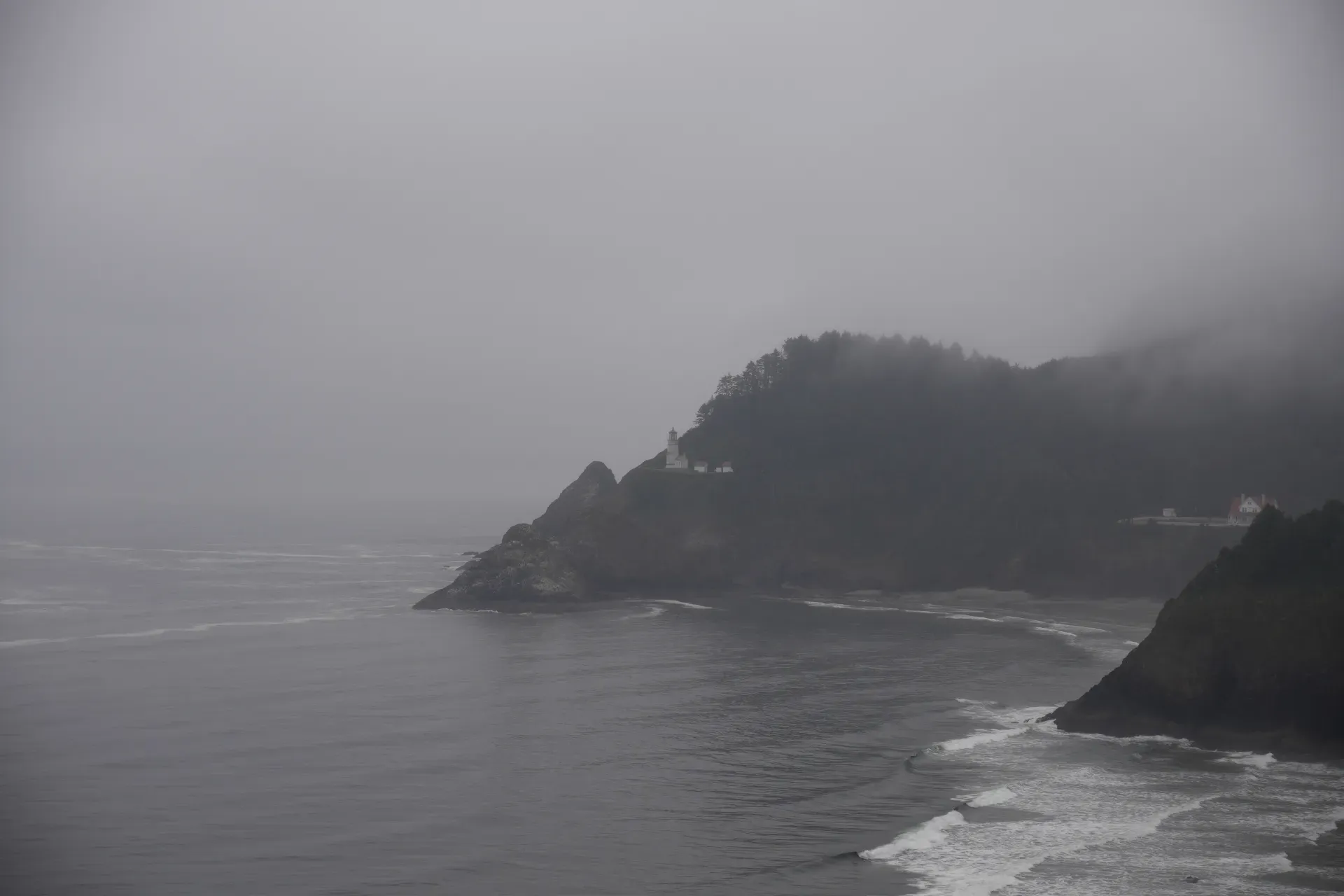 Heceta Head Lighthouse on the foggy coast.