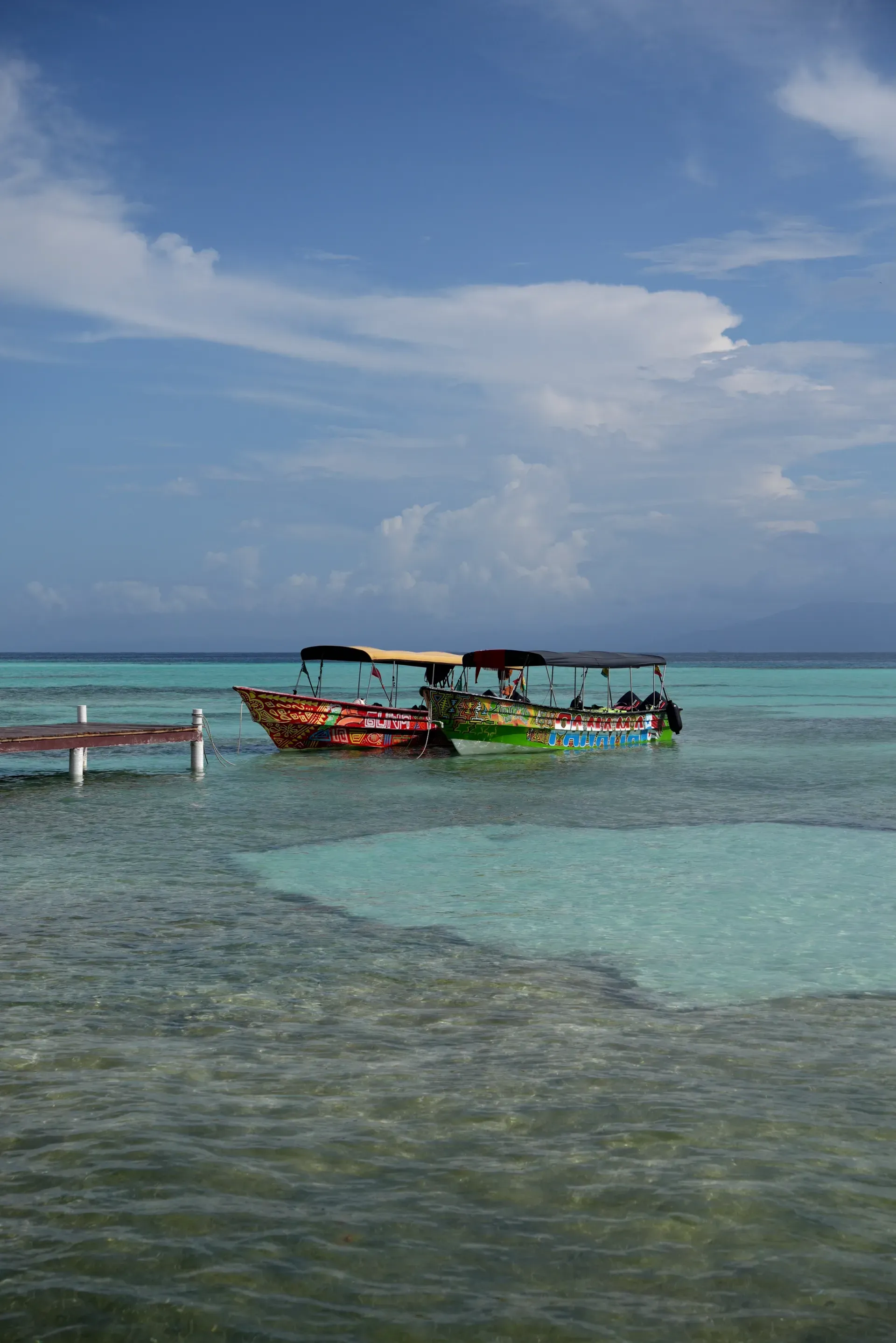 Colorful boats in turquoise water.