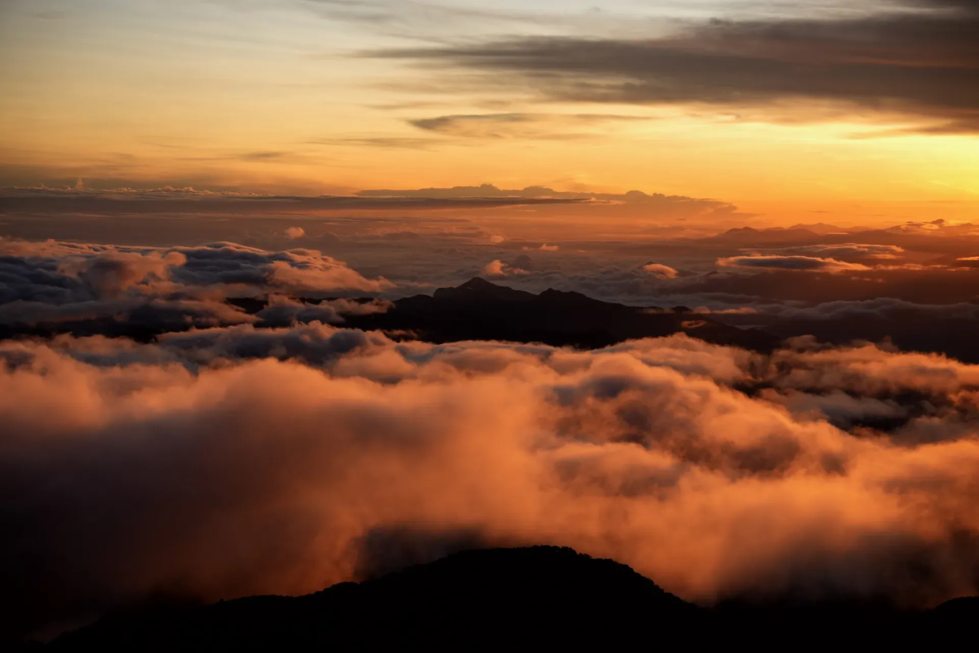 Sunrise clouds and mountain silhouette.