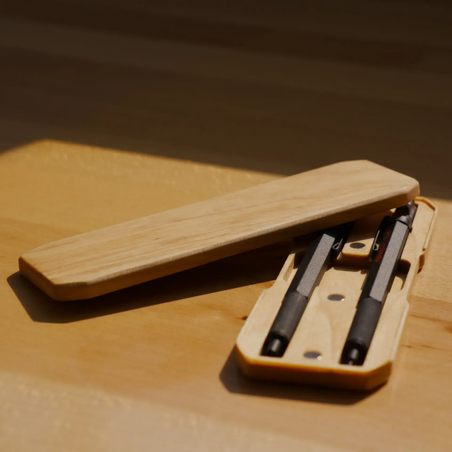 Wooden pencil case on a table.